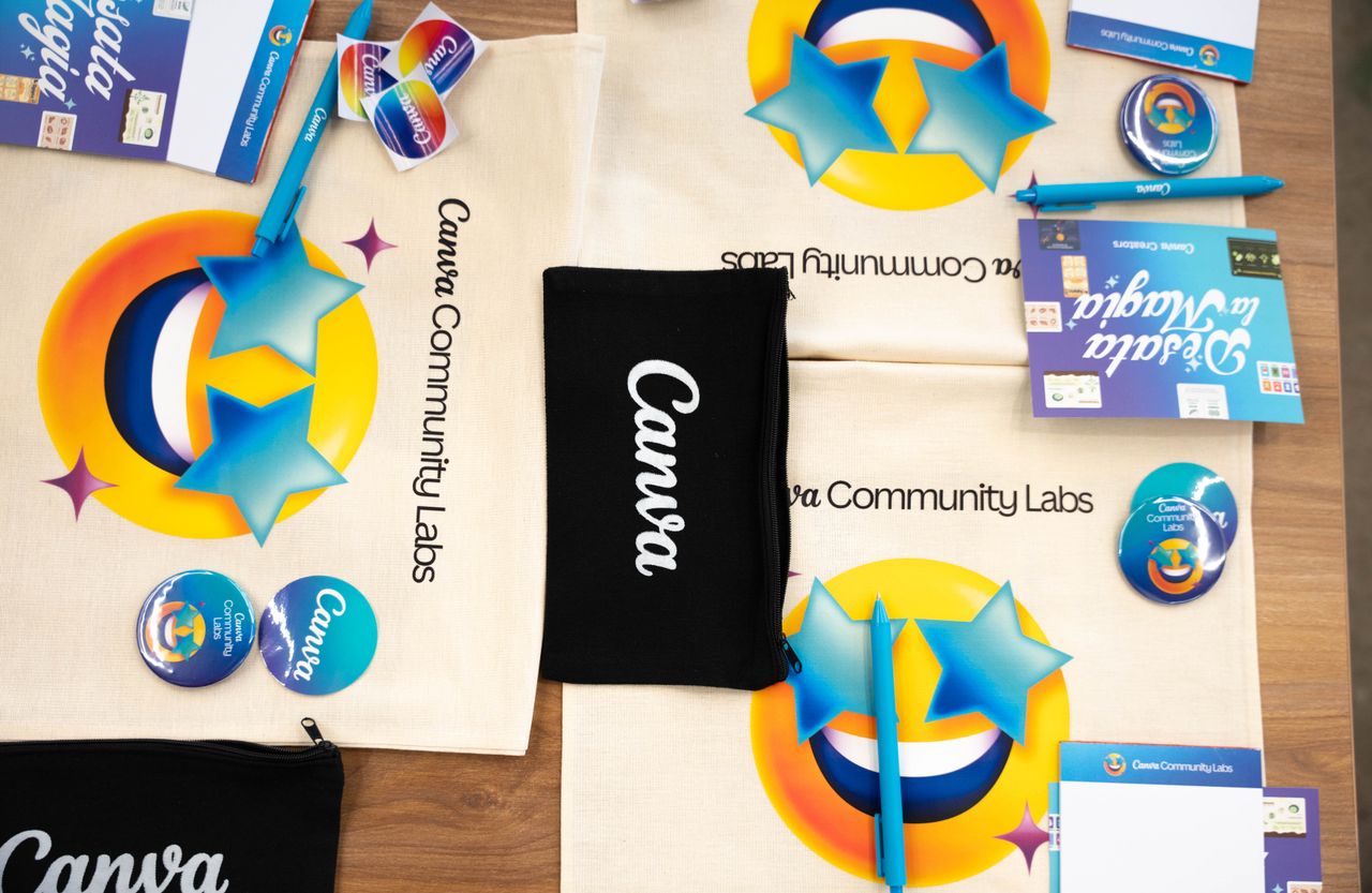 contact-img Flat lay of Canva Community Labs merchandise with vibrant design and branding elements.
